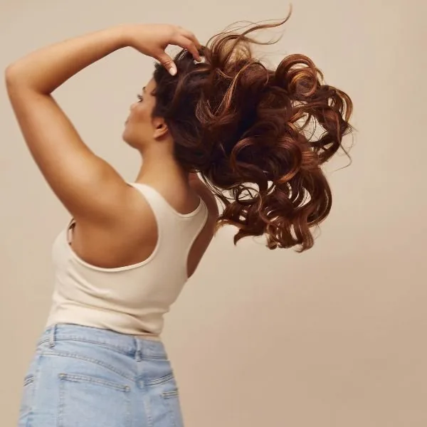 A client with fresh curls at Salon Oasis Med Spa