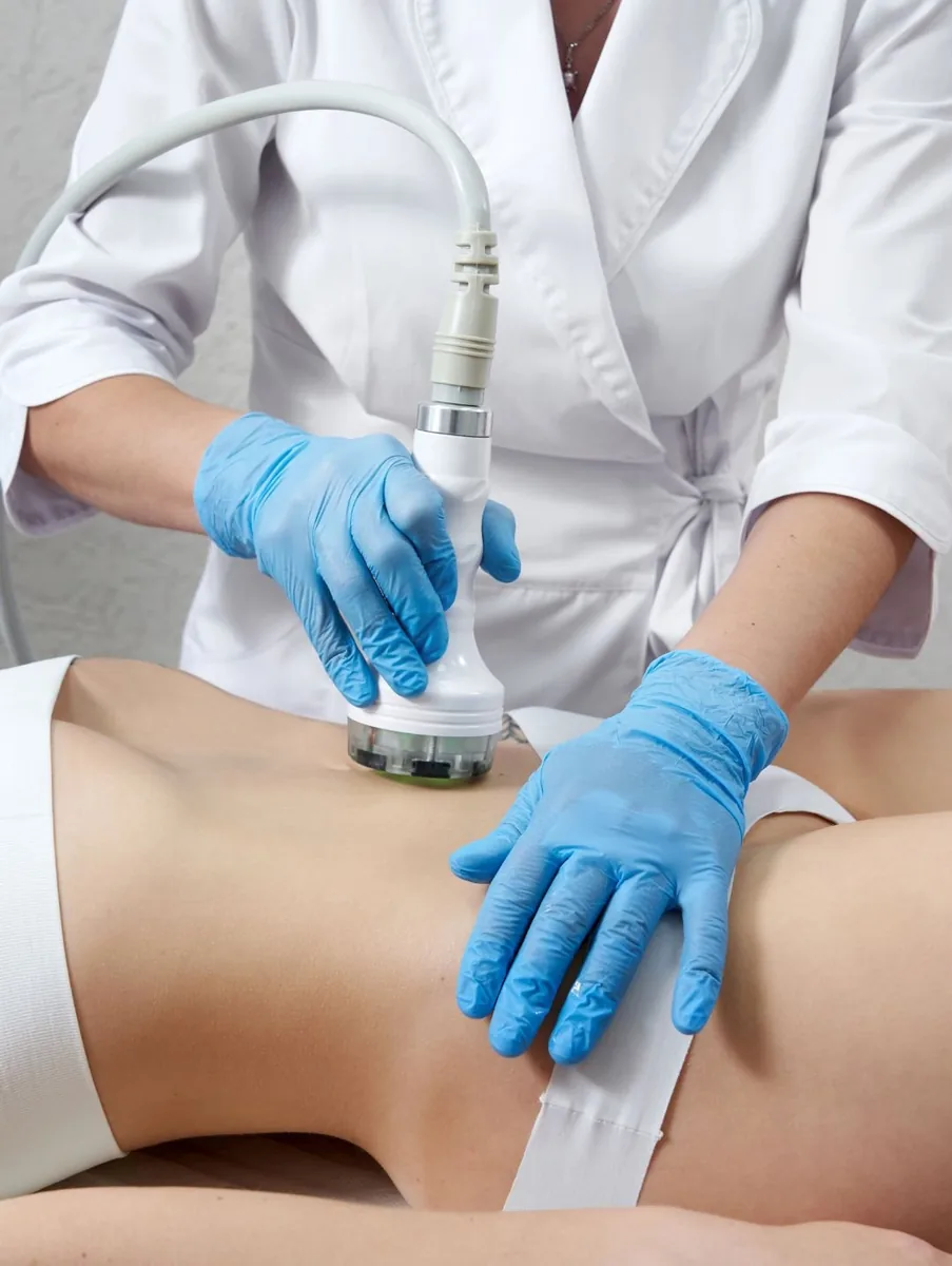 A body contouring handpiece applied to the abdomen