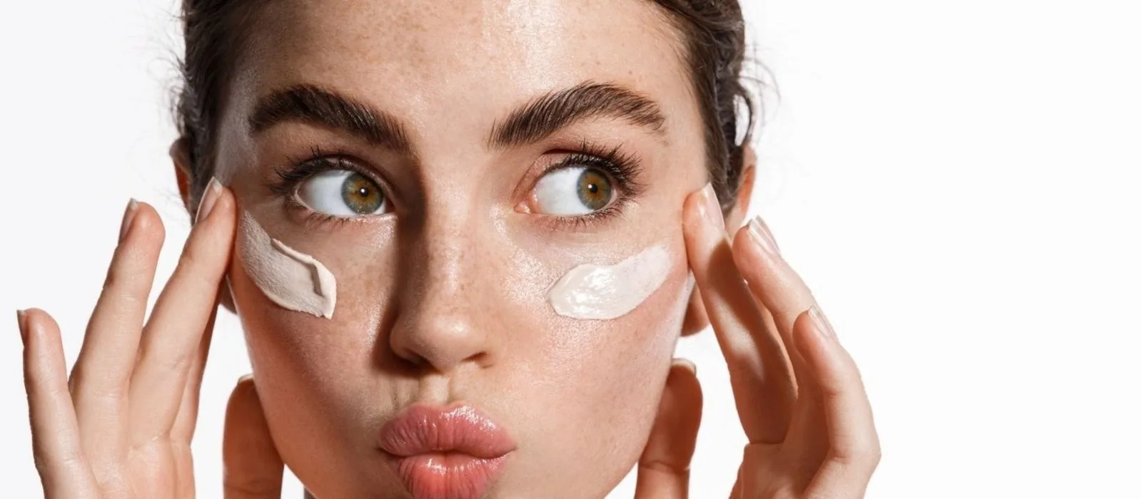 Close-up of a client applying skincare under her eyes